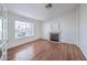 Living room featuring wood floors, a fireplace, and lots of natural light at 4010 Hemphill St, North Las Vegas, NV 89032