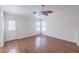Comfortable living room with hardwood floors, a ceiling fan, and a door that leads to the backyard at 4010 Hemphill St, North Las Vegas, NV 89032