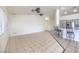 Spacious living area featuring tile floors, a breakfast bar, and neutral paint colors at 4010 Hemphill St, North Las Vegas, NV 89032