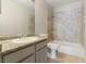 Bathroom featuring a shower and tub combination, granite countertop and gray vanity at 5038 S Rainbow Blvd # 206, Las Vegas, NV 89118