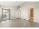 Spacious bedroom with vinyl flooring, sliding glass door to balcony, and access to bathroom at 5038 S Rainbow Blvd # 206, Las Vegas, NV 89118