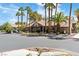Community clubhouse, enhanced by a tile roof, mature palm trees, and xeriscaped landscaping at 5038 S Rainbow Blvd # 206, Las Vegas, NV 89118