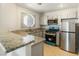 Updated kitchen with granite countertops and stainless steel appliances at 5038 S Rainbow Blvd # 206, Las Vegas, NV 89118