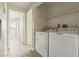 Convenient laundry area with washer, dryer, shelving, and access to other rooms at 5038 S Rainbow Blvd # 206, Las Vegas, NV 89118