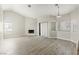 A bright living room featuring wood floors, a fireplace, and multiple windows at 5038 S Rainbow Blvd # 206, Las Vegas, NV 89118