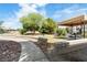 Community picnic area featuring a BBQ, shaded table, sidewalk, and desert landscaping at 5038 S Rainbow Blvd # 206, Las Vegas, NV 89118