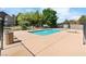 Community pool area with lounge chairs, privacy fencing, and desert landscaping at 5038 S Rainbow Blvd # 206, Las Vegas, NV 89118