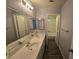 Clean bathroom featuring dual sinks, large mirror, and a separate shower area at 5121 Backwoodsman Ave, Las Vegas, NV 89130