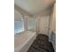 Bathroom with tub, tiled floors, shower, and natural light from window at 5121 Backwoodsman Ave, Las Vegas, NV 89130