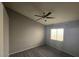 Cozy bedroom featuring neutral walls, ceiling fan, and a window for natural light at 5121 Backwoodsman Ave, Las Vegas, NV 89130