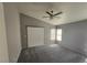 Spacious bedroom featuring gray walls, carpet, and a ceiling fan with light at 5121 Backwoodsman Ave, Las Vegas, NV 89130