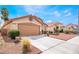 Charming single-story home featuring a two-car garage and tidy front yard landscaping at 5121 Backwoodsman Ave, Las Vegas, NV 89130