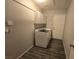 Dedicated laundry room with modern appliances, cabinetry, and sleek tile flooring at 5121 Backwoodsman Ave, Las Vegas, NV 89130