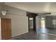 Open-concept living area with tile floors, large mirrors, and view of the front entry at 5121 Backwoodsman Ave, Las Vegas, NV 89130