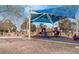 Community playground featuring slides and climbing structures under a blue canopy at 5121 Backwoodsman Ave, Las Vegas, NV 89130