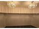 Walk-in closet featuring carpet, shelving, and two decorative chandeliers at 5121 Backwoodsman Ave, Las Vegas, NV 89130