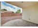 An empty backyard features a patio and a low red brick wall, perfect for creating an outdoor oasis at 525 Sun Mountain Ave, North Las Vegas, NV 89031