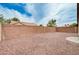 An enclosed backyard is surfaced with decorative gravel and features a red brick wall at 525 Sun Mountain Ave, North Las Vegas, NV 89031