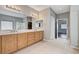 Bathroom with double sink vanity, mirrors, and tile floors at 525 Sun Mountain Ave, North Las Vegas, NV 89031