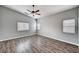 Spacious bedroom with ceiling fan, wood-look floors, and natural light at 525 Sun Mountain Ave, North Las Vegas, NV 89031
