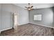Bright bedroom featuring a ceiling fan, wood-look floors, and neutral paint at 525 Sun Mountain Ave, North Las Vegas, NV 89031