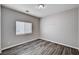 Empty bedroom with new hard surface floors, and a large window at 525 Sun Mountain Ave, North Las Vegas, NV 89031