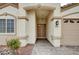 Covered entryway with double doors, stone landscaping, and a brick paved driveway at 525 Sun Mountain Ave, North Las Vegas, NV 89031