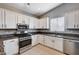 Well lit kitchen with stainless steel appliances and granite countertops at 525 Sun Mountain Ave, North Las Vegas, NV 89031