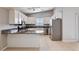 Updated kitchen featuring modern appliances, granite countertops, and a breakfast bar at 525 Sun Mountain Ave, North Las Vegas, NV 89031