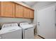 Laundry room featuring a washer, dryer, sink, storage cabinets, and a door to the outside at 525 Sun Mountain Ave, North Las Vegas, NV 89031