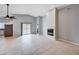 Bright living space featuring tile flooring, a modern fireplace, and access to the kitchen and patio at 525 Sun Mountain Ave, North Las Vegas, NV 89031