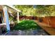 Lush backyard featuring artificial turf, a stamped concrete patio, and mature trees at 5466 Fawn Chase Way, Las Vegas, NV 89135