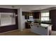 Spacious kitchen with an island, dark cabinetry, and modern appliances at 5466 Fawn Chase Way, Las Vegas, NV 89135