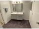 Bathroom features a vanity with drawers, mirror, and carpeted floor at 555 E Silverado Ranch Blvd # 2030, Las Vegas, NV 89183