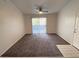 Spacious bedroom with carpet, ceiling fan, and a sliding door to a balcony at 555 E Silverado Ranch Blvd # 2030, Las Vegas, NV 89183
