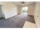 Bright bedroom with neutral carpet, ceiling fan, and sliding door to a balcony at 555 E Silverado Ranch Blvd # 2030, Las Vegas, NV 89183
