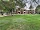 Well-manicured lawn with lush grass and mature trees surrounding a multi-story apartment building at 555 E Silverado Ranch Blvd # 2030, Las Vegas, NV 89183