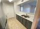 Galley kitchen features stainless steel appliances and gray cabinets at 555 E Silverado Ranch Blvd # 2030, Las Vegas, NV 89183