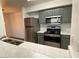 Well-lit kitchen featuring stainless steel appliances, gray cabinets, and white countertops at 555 E Silverado Ranch Blvd # 2030, Las Vegas, NV 89183