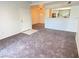 Open living space with modern carpet and a view into the kitchen at 555 E Silverado Ranch Blvd # 2030, Las Vegas, NV 89183