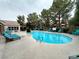 Community pool surrounded by chairs and trees at 555 E Silverado Ranch Blvd # 2030, Las Vegas, NV 89183