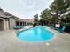 A winding community pool with blue lounge chairs on the deck at 555 E Silverado Ranch Blvd # 2030, Las Vegas, NV 89183