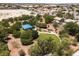 Aerial view of a park with a covered picnic area, walking paths, and lush trees creating a serene community space at 5620 Siena Rose St, North Las Vegas, NV 89031