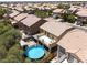 Aerial view of a backyard with an above-ground pool, patio area, and surrounding greenery at 5620 Siena Rose St, North Las Vegas, NV 89031
