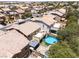 Aerial view of homes in a neighborhood, featuring pools, patios, and well-maintained yards at 5620 Siena Rose St, North Las Vegas, NV 89031