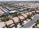 Expansive aerial view of a suburban neighborhood with well-maintained homes and tree-lined streets, near shopping and services at 5620 Siena Rose St, North Las Vegas, NV 89031