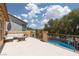 Comfortable balcony with outdoor seating area overlooking the pool and backyard at 5620 Siena Rose St, North Las Vegas, NV 89031