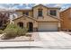 Charming two-story home with a desert landscape, two-car garage and tile roof in a residential neighborhood at 5620 Siena Rose St, North Las Vegas, NV 89031