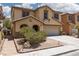 Charming two-story home with a desert landscape, two-car garage and tile roof in a residential neighborhood at 5620 Siena Rose St, North Las Vegas, NV 89031