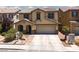 Charming two-story home with a desert landscape, two-car garage and tile roof in a residential neighborhood at 5620 Siena Rose St, North Las Vegas, NV 89031